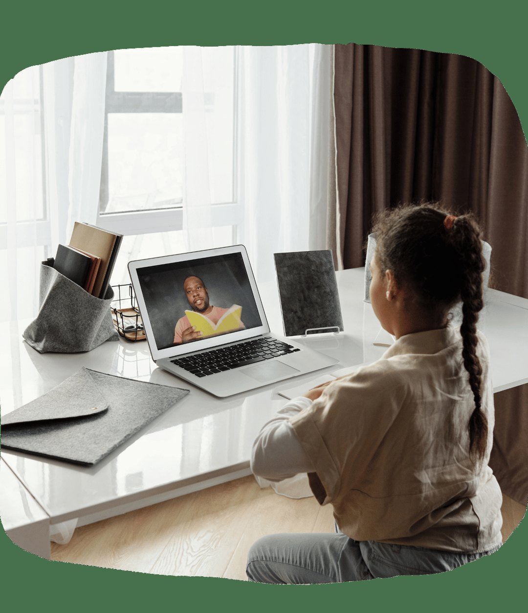 A student learning online with an adult guide on a laptop